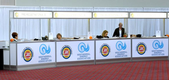 Modern corporate registration booth with branding for the Geothermal Energy Association, showcasing marketing design.