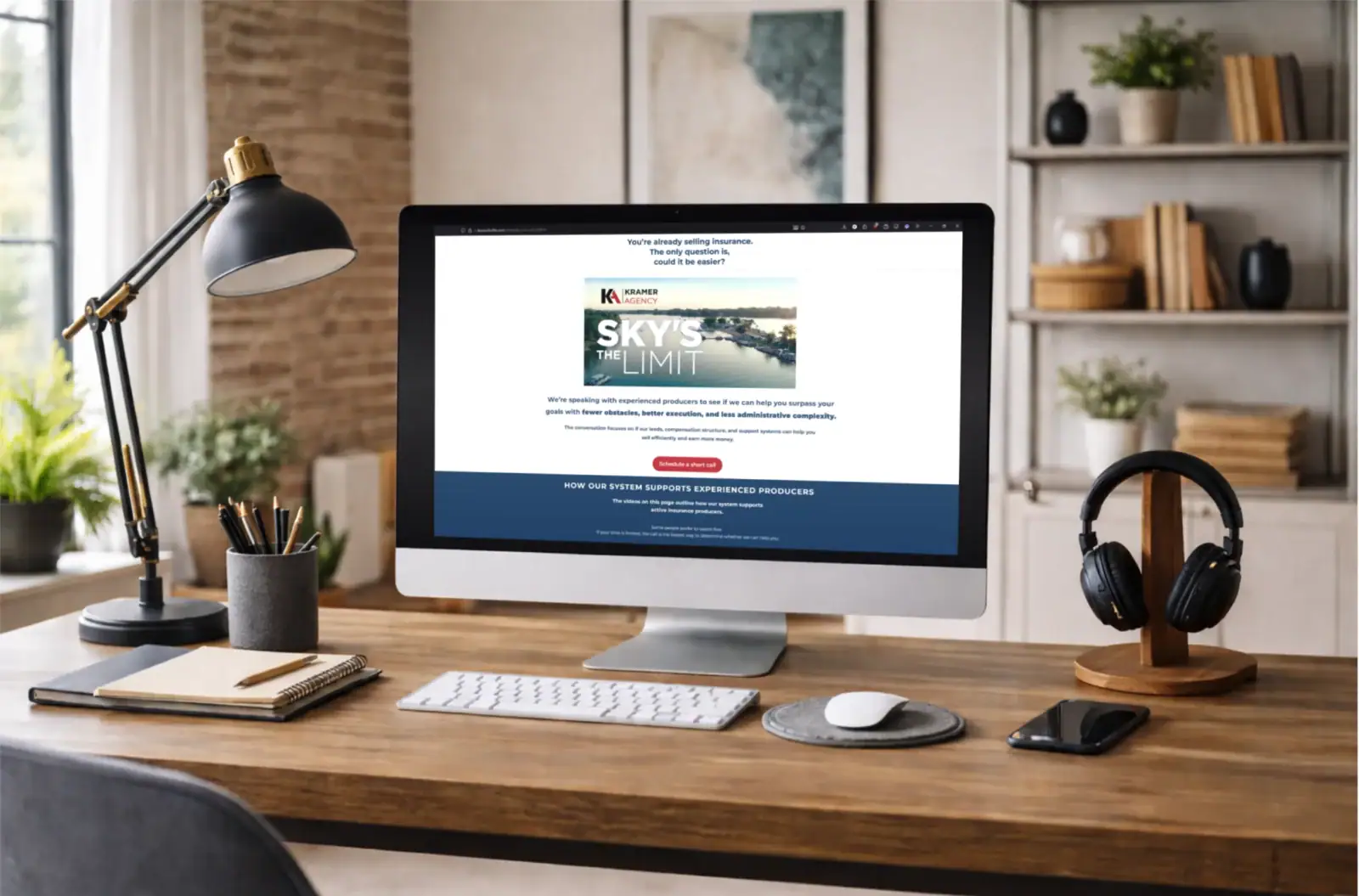 A sleek workspace featuring a desktop computer, headphones, and office supplies in a cozy, well-orga.