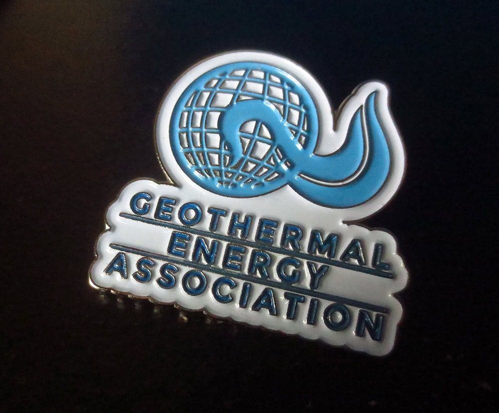 Enamel pin design featuring the Geothermal Energy Association logo with globe and wave motifs.