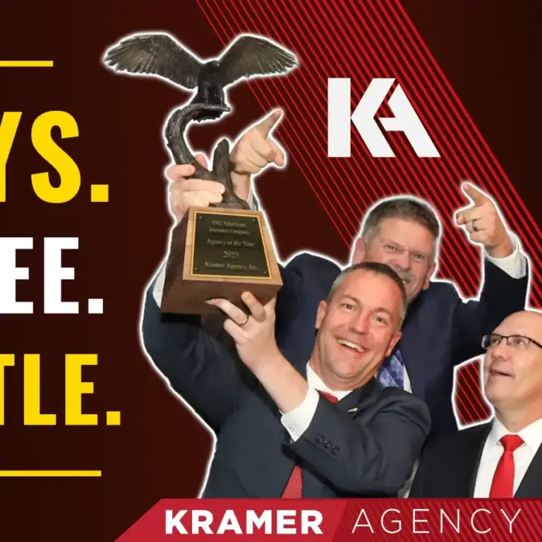 Eagle trophy held by smiling man in suit with two colleagues, celebrating achievement in a professio.