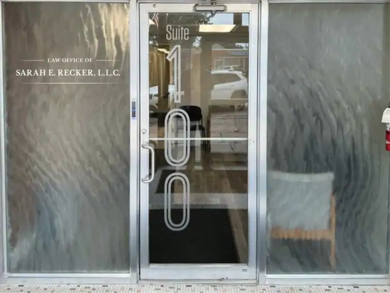Law office entrance with glass door and metallic wall, professional commercial design.