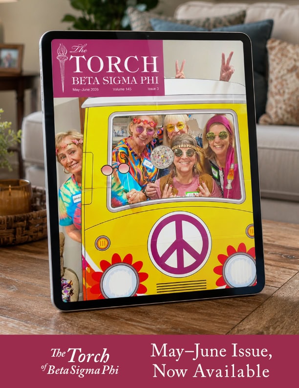 Bright yellow vintage van with peace symbol and floral accents, featuring four women in colorful 196.